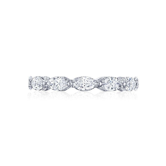 The Tacori Classic Crescent RoyalT 18K White Gold Marquise Cut Pear Diamond Anniversary Ring displays a continuous row of oval, round, and marquise-shaped diamonds that reflect light for a breathtaking shimmer. This delicate band is crafted by Tacori and exemplifies timeless beauty with its elegant, symmetrical design.
