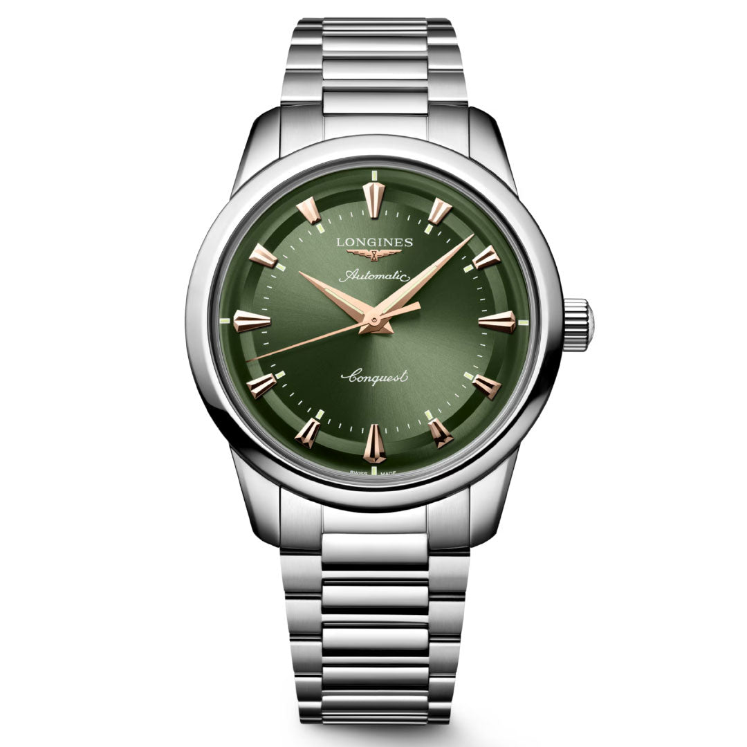 The Longines Conquest Heritage Automatic 40mm Watch features a silver metal case, green dial with gold hour markers and hands, "Longines" at the top, and a classic metal link bracelet for a timeless vintage look.
