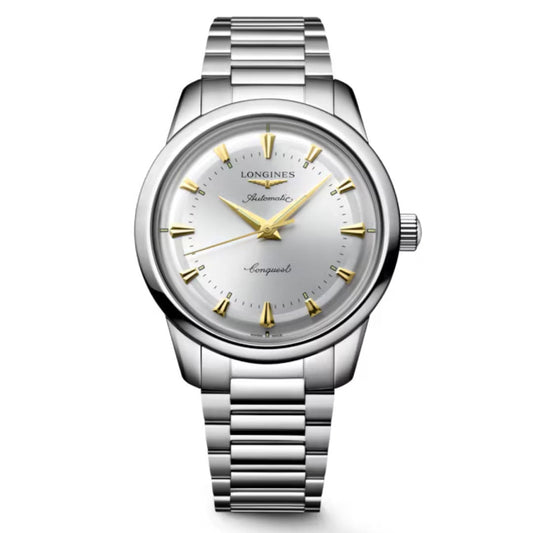 The Longines Conquest Heritage Automatic 40mm Watch has a stainless steel case, silver dial, gold markers and hands, metal link band, and displays "Longines Automatic Conquest" on its vintage-inspired face.