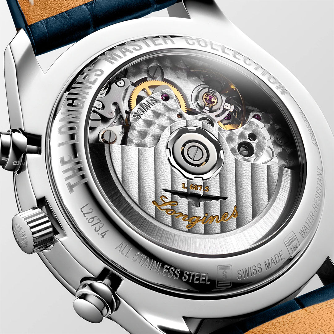 Close-up of the Longines Master Collection Automatic Moonphase 40mm Watch, highlighting Swiss craftsmanship and its intricate automatic movement visible through a transparent caseback, with detailed engravings and a blue leather strap by Longines.