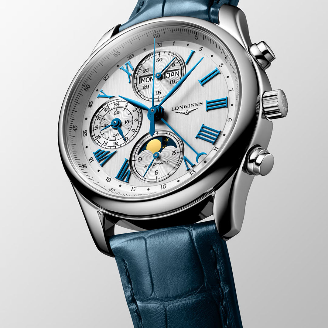 The Longines Master Collection Automatic Moonphase 40mm Watch features a blue leather strap, silver case, blue Roman numerals and hands, and multiple dials for time, day, month, and moon phase—a testament to Longines craftsmanship.