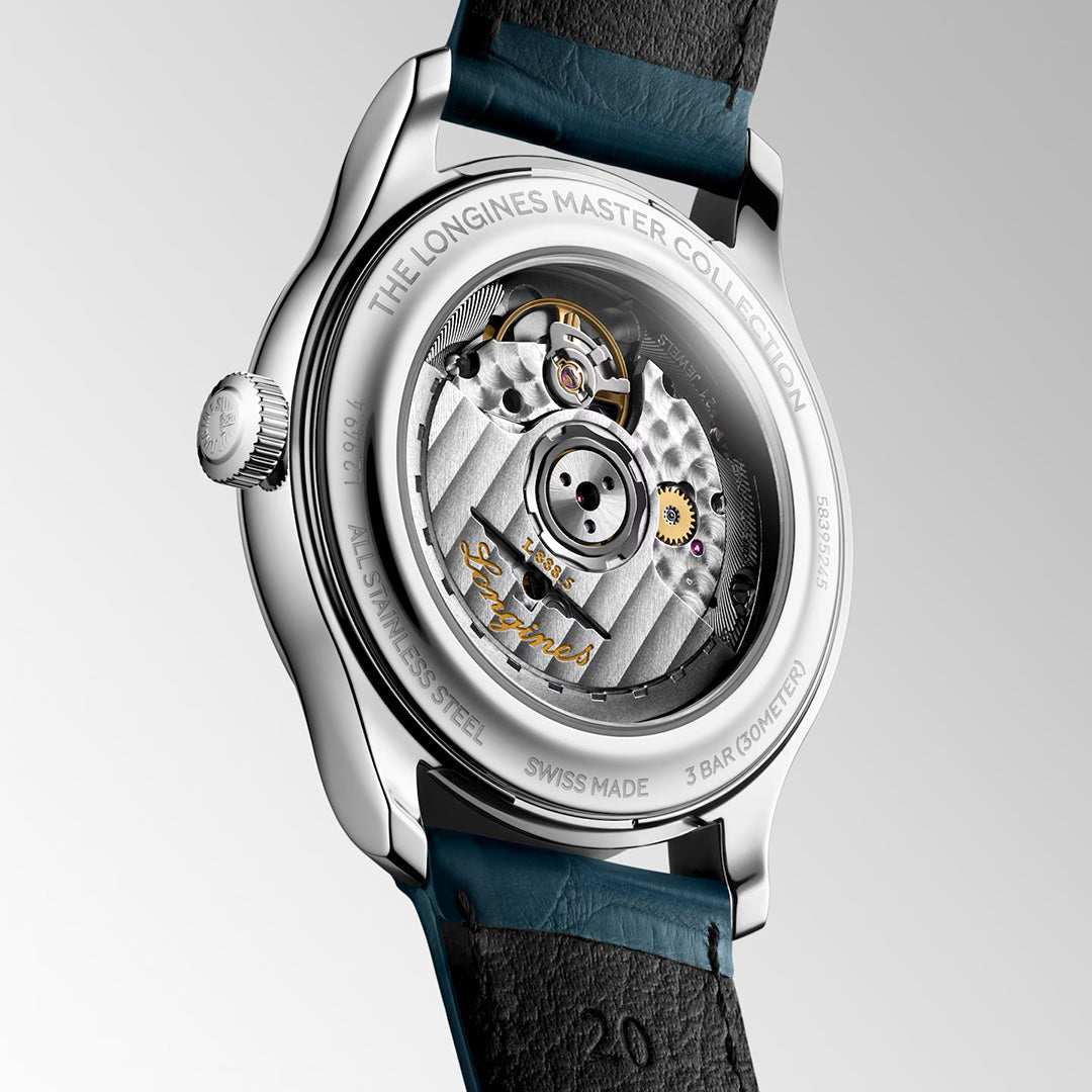 The Longines Master Collection Automatic 39mm Watch features a transparent case back that reveals its intricate mechanical movement, embodying the artistry of Swiss watchmaking. The engraved details and sophisticated blue leather strap further showcase the refined craftsmanship that distinguishes Longines luxury timepieces.