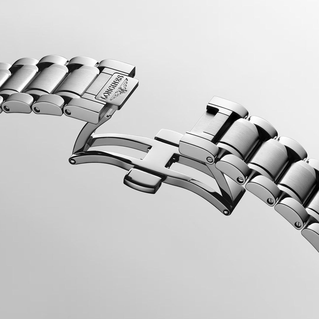 Close-up of an open stainless steel bracelet with a deployment clasp, highlighting the brushed and polished metal links against a plain light gray background—a refined detail from the Longines Master Collection Automatic 39mm Watch by Longines.