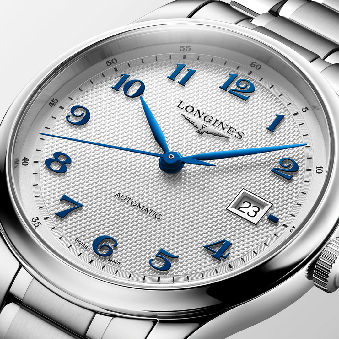 A detailed close-up of the Longines Master Collection Automatic 41mm Watch by Longines highlights its stainless steel bracelet, silver case, textured white dial with blue hands and blue Arabic numerals, date display at 3 o’clock, and showcases exquisite traditional watchmaking artistry.