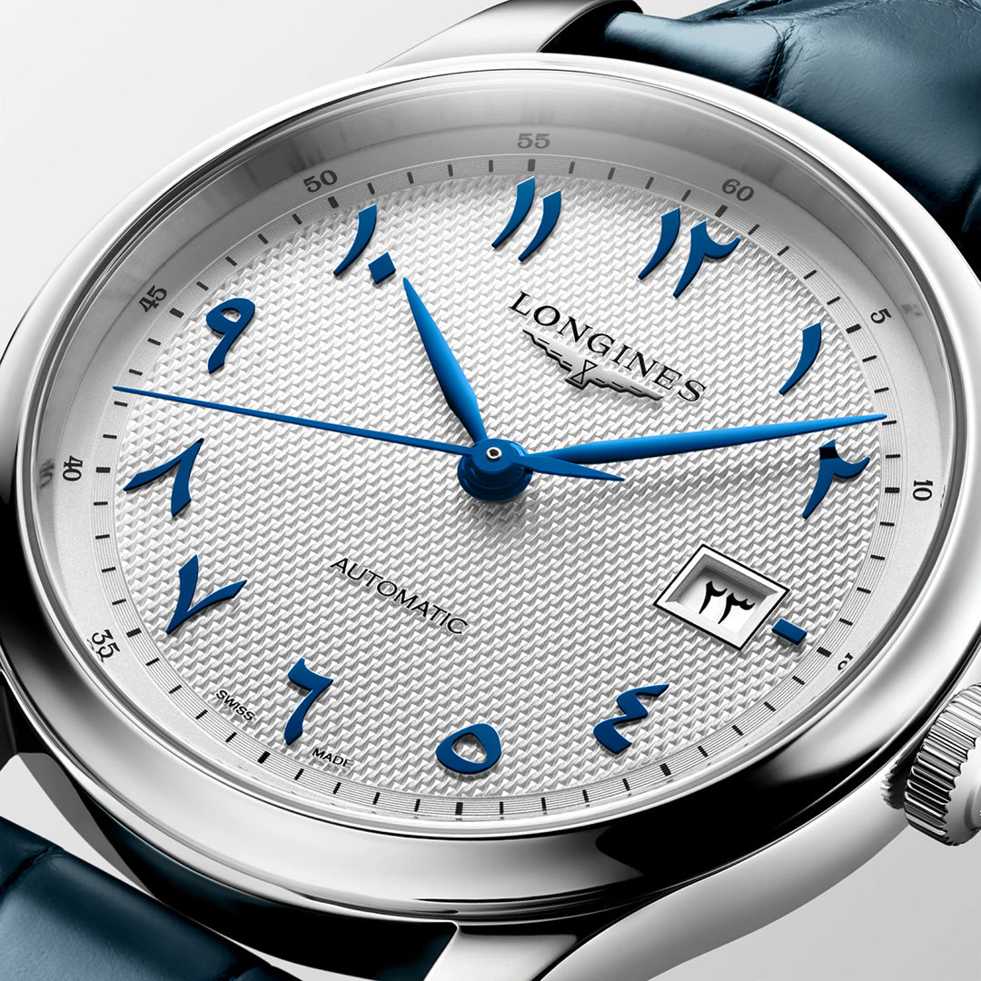 A close-up of the Longines Master Collection Automatic 41mm Watch by Longines, featuring a textured white dial with blue Arabic numerals, elegant blue hands, and a date window—all encased in a polished silver case and paired with a sophisticated blue leather strap—an exquisite demonstration of luxury timepieces and fine watchmaking.