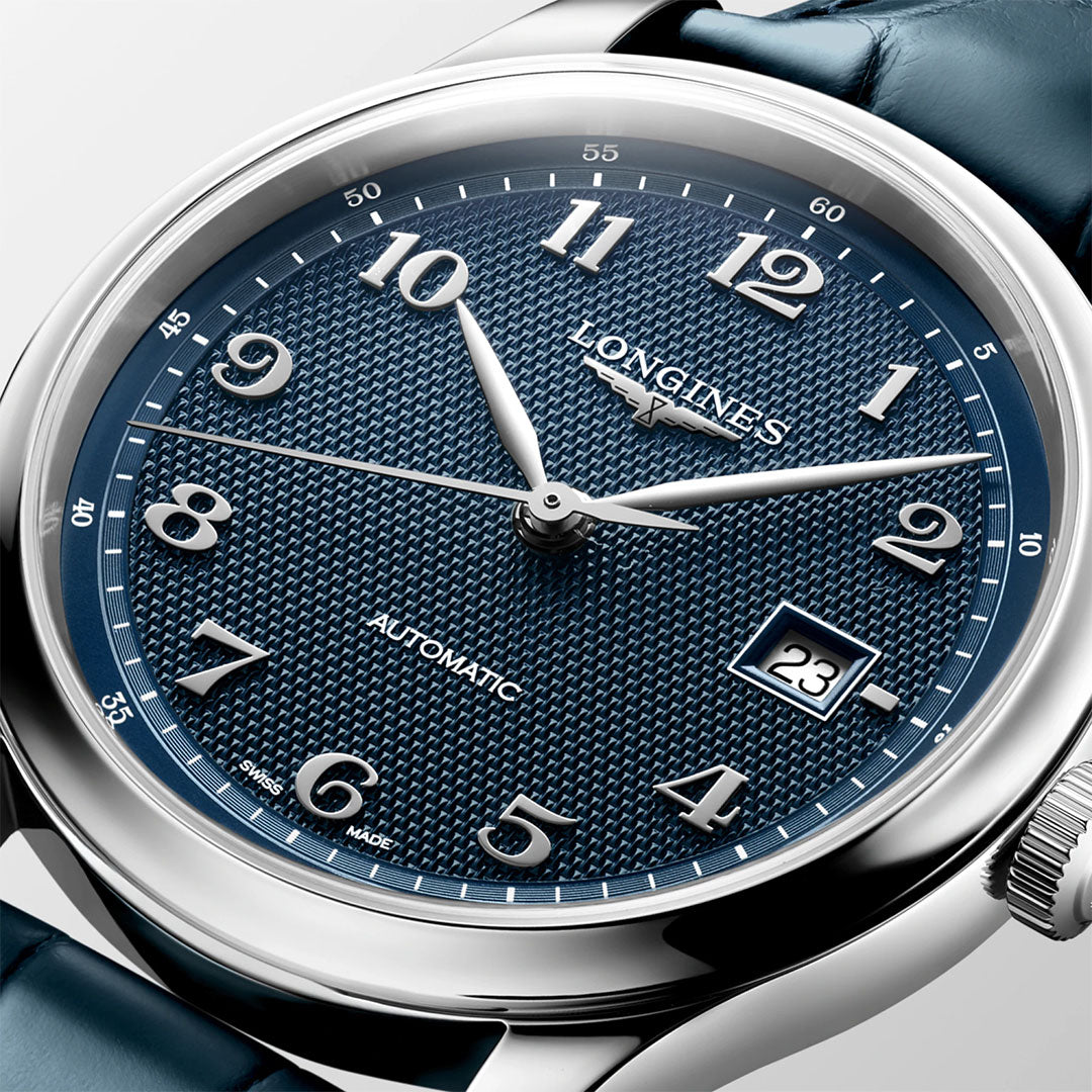 A close-up of the Longines Master Collection Automatic 41mm Watch by Longines, featuring a textured blue dial with silver hour markers, a date window at 3 o’clock, and a blue leather strap. The time displayed is approximately 10:09:35—an elegant testament to Longines’ expertise in luxury watchmaking.