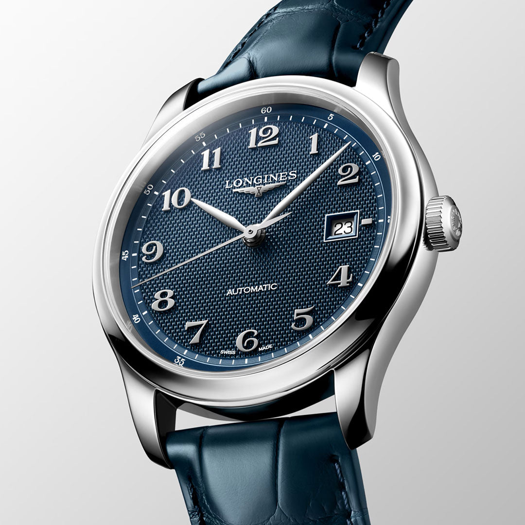 A close-up of the Longines Master Collection Automatic 41mm Watch by Longines, featuring a blue textured dial with silver numerals, a date window at 3 o’clock, and a blue leather strap. The polished silver case accentuates the exceptional craftsmanship and meticulous attention to detail characteristic of this luxury timepiece.