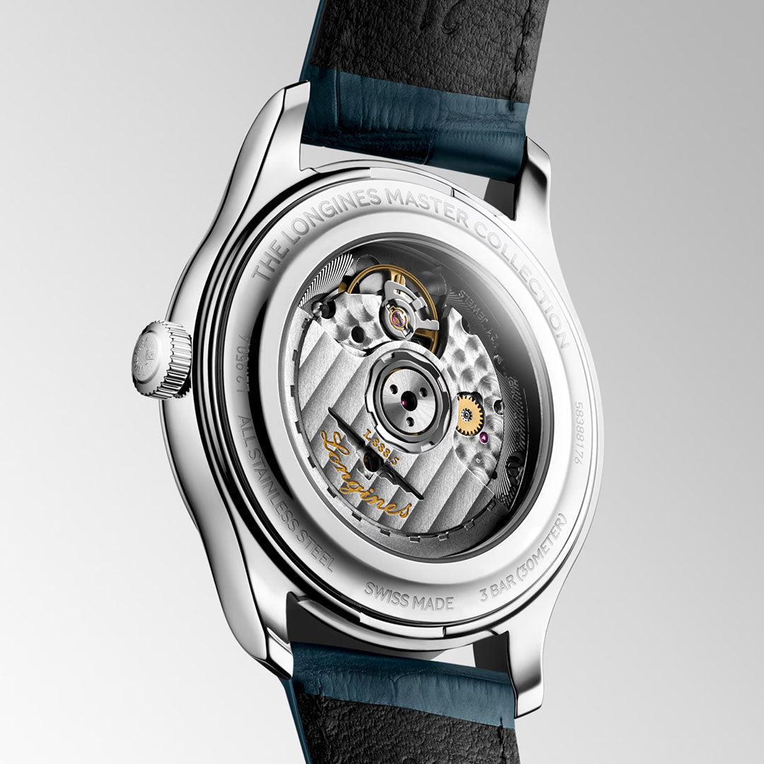 Close-up of the back of the Longines Master Collection Automatic 41mm Watch by Longines, showcasing the intricate mechanical movement through its transparent caseback—a testament to expert watchmaking—with visible gears and engraved details on the metal components, reflecting the enduring craftsmanship found in luxury timepieces.