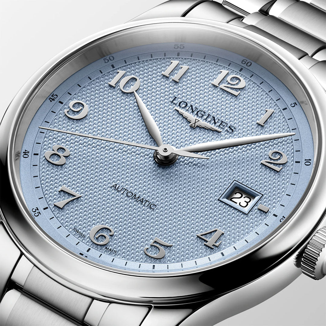 A close-up of the Longines Master Collection Automatic 41mm Watch by Longines, showcasing its textured light blue dial with polished silver hour markers, a date window at 3 o’clock, and a sleek metal bracelet. The refined hands and elegant detailing exemplify Swiss watchmaking sophistication and luxury craftsmanship.