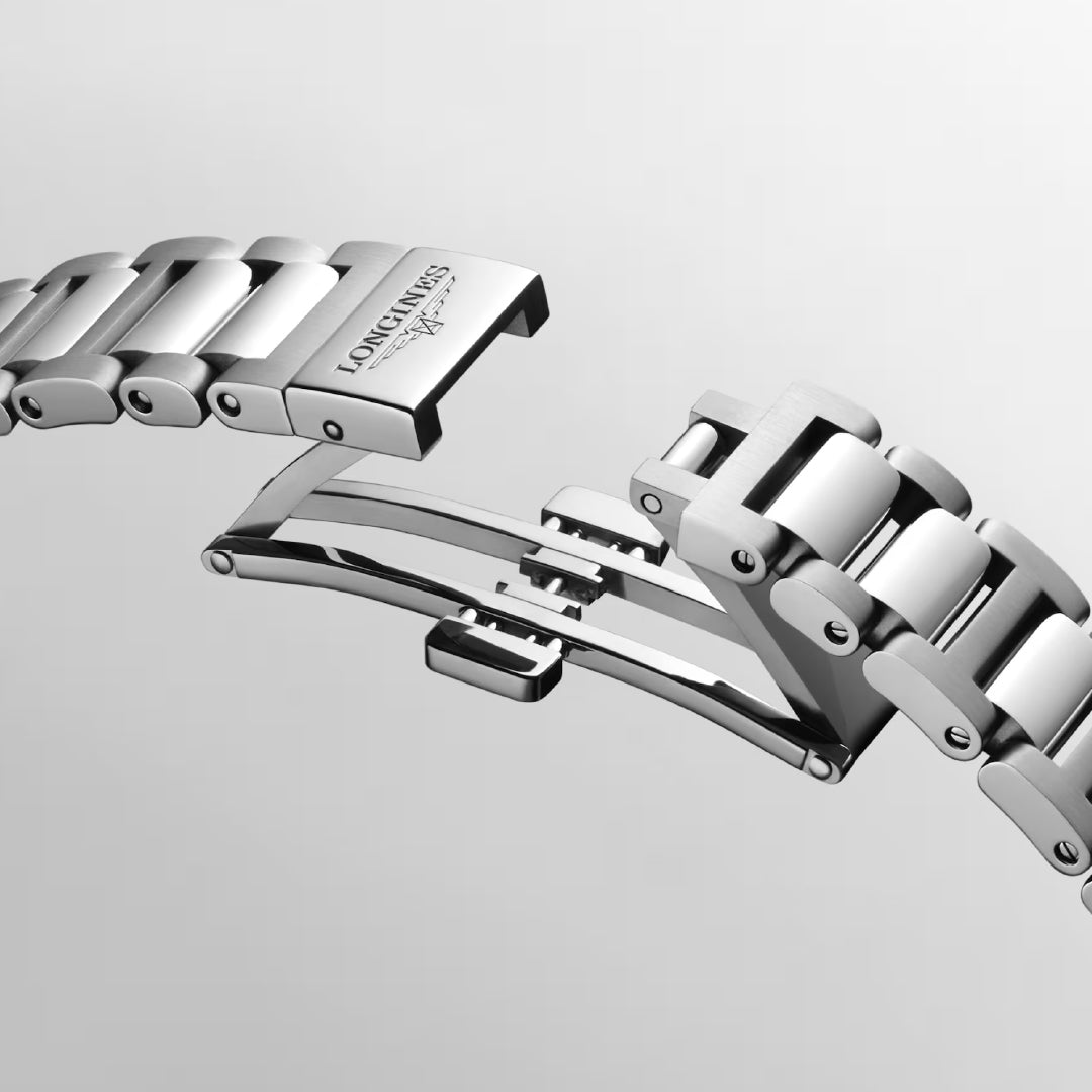 Close-up of the stainless steel bracelet of the Longines Conquest Automatic 30mm Watch, showcasing a butterfly clasp with the "LONGINES" logo engraved on the buckle. This piece from the Conquest collection emphasizes its elegant clasp mechanism against a plain gray background, embodying everyday sophistication.