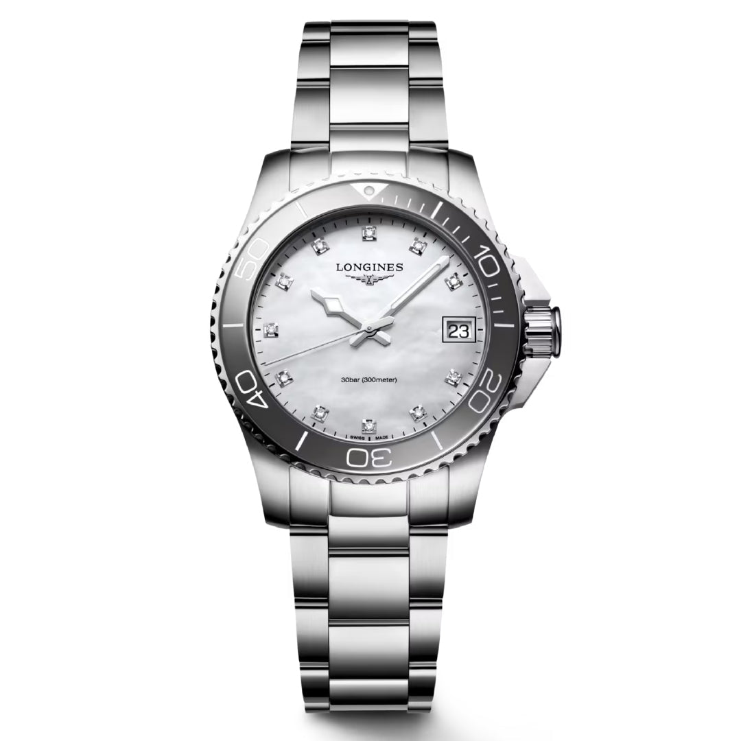 The Longines HydroConquest Quartz 32mm Watch boasts a stainless steel band, white dial with silver markers, date display at 3 o'clock, and unidirectional rotating bezel. Ideal for water sports lovers, it prominently features the Longines logo on the sleek silver design.