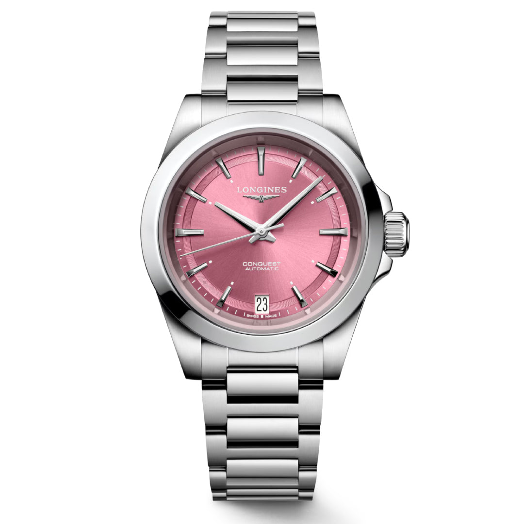 Discover the horological excellence of the Longines Conquest Automatic 34mm Watch. This stainless steel timepiece by Longines showcases a pink dial with silver hour markers and includes a date display at 3 o'clock. It features a round case, a metal link bracelet, and is elegantly designed with the brand logo displayed at 12 o'clock on the dial.