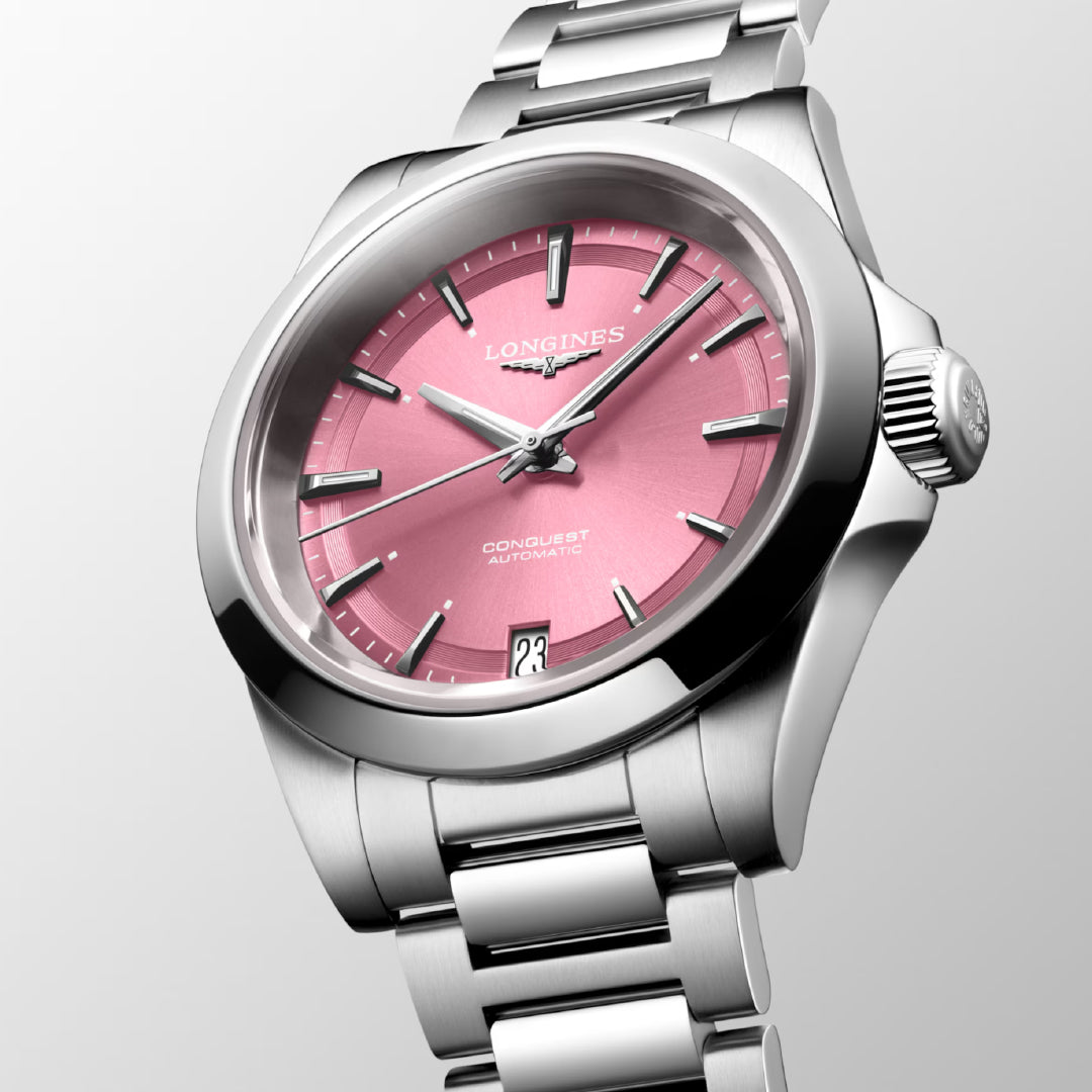 Experience horological excellence with the Longines Conquest Automatic 34mm Watch. This exquisite timepiece features a pink dial, silver hour markers, and an automatic movement—a true embodiment of the Conquest collection. Its visible date window at 6 o'clock and polished metal bracelet reflect the renowned style and precision of Longines.