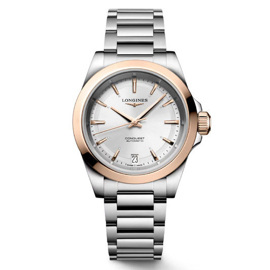 The Longines Conquest Automatic 34mm Watch exemplifies horological excellence with its silver and rose gold design. It features a metallic strap, a round white dial adorned with gold hour markers, and includes a date display at the 3 o'clock position. The distinguished LONGINES Conquest name is elegantly displayed on the dial.