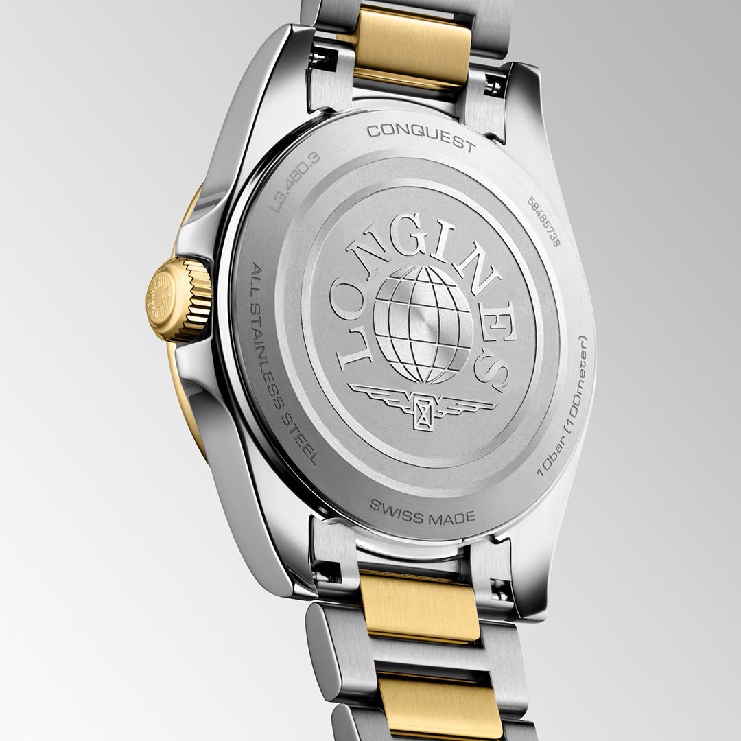 The back of a two-tone silver and gold Longines Conquest Quartz 34mm Watch featuring an engraved globe logo, brand name, and water resistance information.