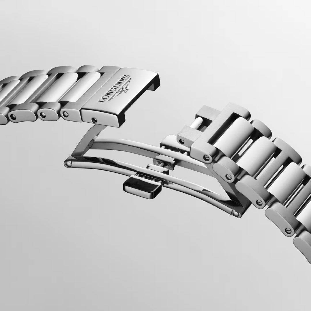 A close-up of a silver stainless steel bracelet on the Longines Conquest Automatic 38mm Watch, showcasing its detailed links and folding clasp mechanism with the Longines branding against a light grey background.