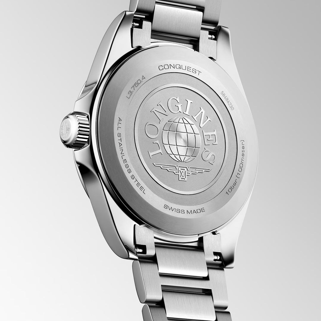 The back of a stainless steel Longines Conquest Quartz 38mm Watch, showing the metal case back engraved with a globe logo and technical specifications including water resistance.