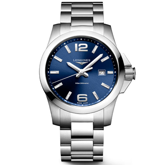 The Longines Conquest Quartz 43mm Watch features a blue dial, silver markers and hands, date window at 3 o’clock, stainless steel case and bracelet, shown against a white background.