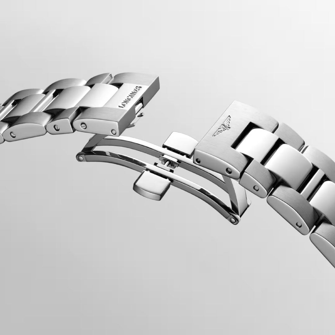 Close-up of the stainless steel bracelet and deployant clasp of the Longines Conquest Quartz 43mm Watch, partially open to reveal its detailed metal links—a refined feature of this Longines timepiece against a plain light gray background.