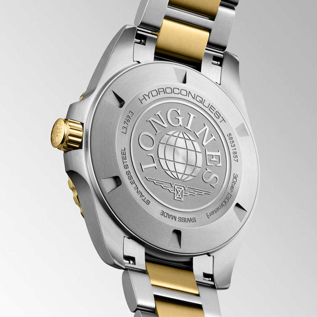 The back of the Longines HydroConquest Quartz 42mm Watch highlights the artistry of Swiss watchmaking, displaying engraved Longines branding, a globe logo, serial numbers, and a striking two-tone stainless steel and gold bracelet—reflecting the brand’s enduring commitment to excellence in sport watches.