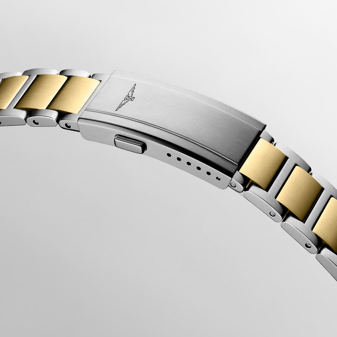 Close-up of the Longines HydroConquest Quartz 42mm Watch bracelet displays alternating silver and gold links in a two-tone design, with a clasp engraved with the brand’s signature winged emblem against a plain light background—an exemplary piece of Swiss watchmaking from Longines, highly regarded among sport watch aficionados.