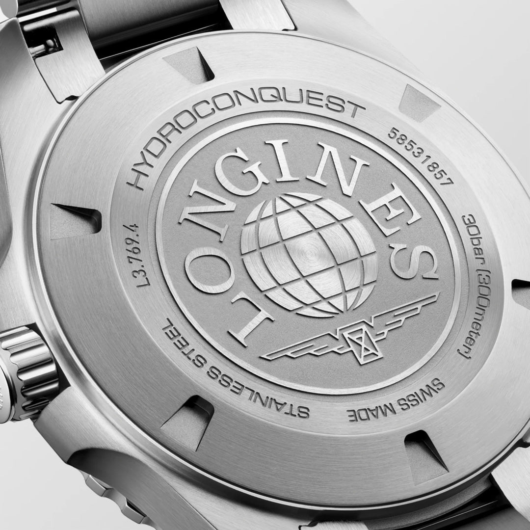 Here’s a rewritten version using your product data: Close-up of the back of the Longines HydroConquest Quartz 42mm Watch highlights engraved details such as the Longines brand name, a globe emblem, and inscriptions noting water resistance, stainless steel material, and serial number—testament to this Swiss sport watch’s renowned precision and craftsmanship.