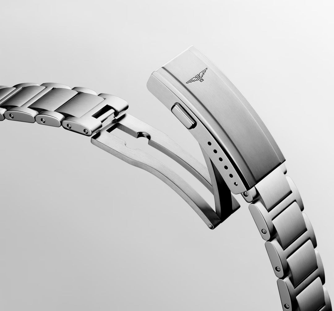 A close-up of the stainless steel bracelet of the Longines HydroConquest Quartz 42mm Watch reveals its open clasp, finely crafted locking mechanism, and a subtle engraved Longines logo—highlighting the precision engineering characteristic of Longines’ renowned robust sport watches.