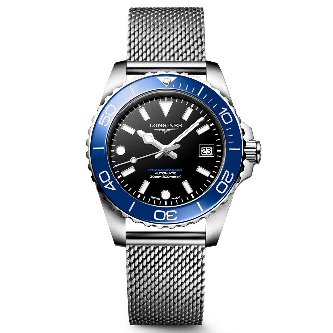Introducing the Longines HydroConquest Automatic 39mm Watch: a Swiss timepiece from the celebrated HydroConquest sport collection. Featuring a striking silver mesh metal band, elegant blue bezel, black dial, and silver hour markers, this watch displays the date at 3 o’clock and prominently showcases the “Longines” branding on its face.
