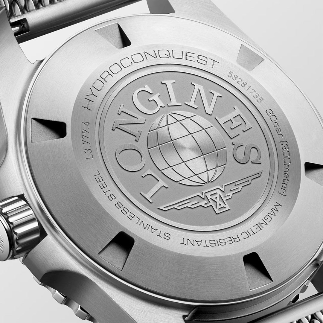 Close-up of the caseback of the Longines HydroConquest Automatic 39mm Watch, featuring the engraved Longines logo with a globe and wings, as well as technical details about water resistance, magnetic resistance, stainless steel construction, and model numbers.