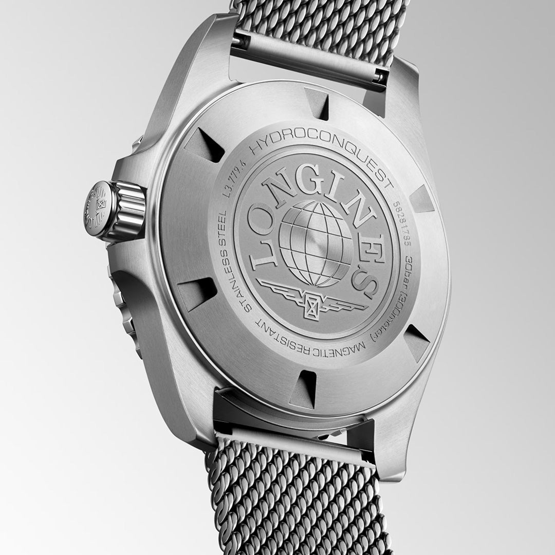 A close-up of the back of the Longines HydroConquest Automatic 39mm Watch showcases its stainless steel construction, engraved logo, globe motif, and metal mesh strap from Longines—highlighting exceptional Swiss watch craftsmanship.