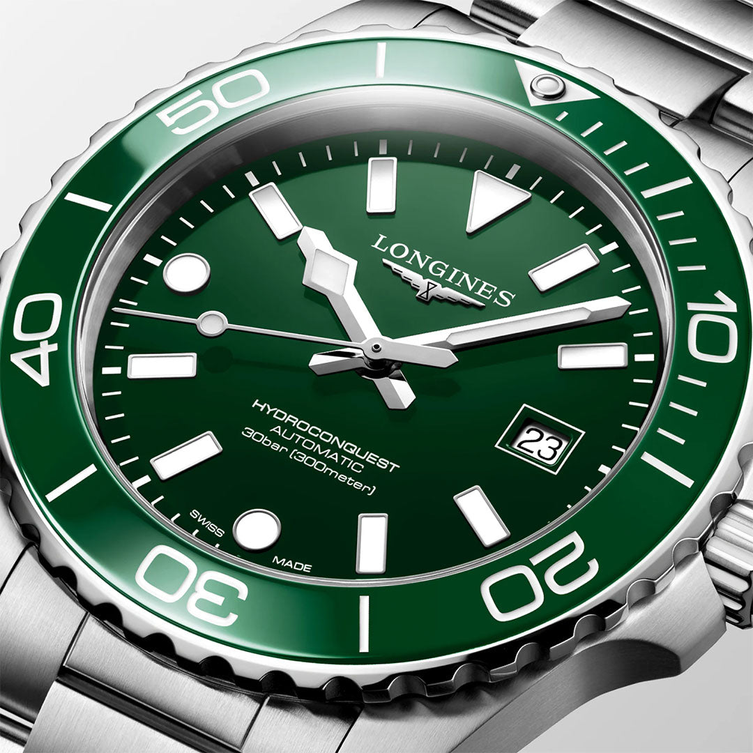 Close-up of the Longines Hydroconquest Automatic 42mm Watch, featuring a green bezel and dial, bold white markers with Swiss Super-Luminova, date at 3 o'clock, and 300m water resistance. Brand: Longines.