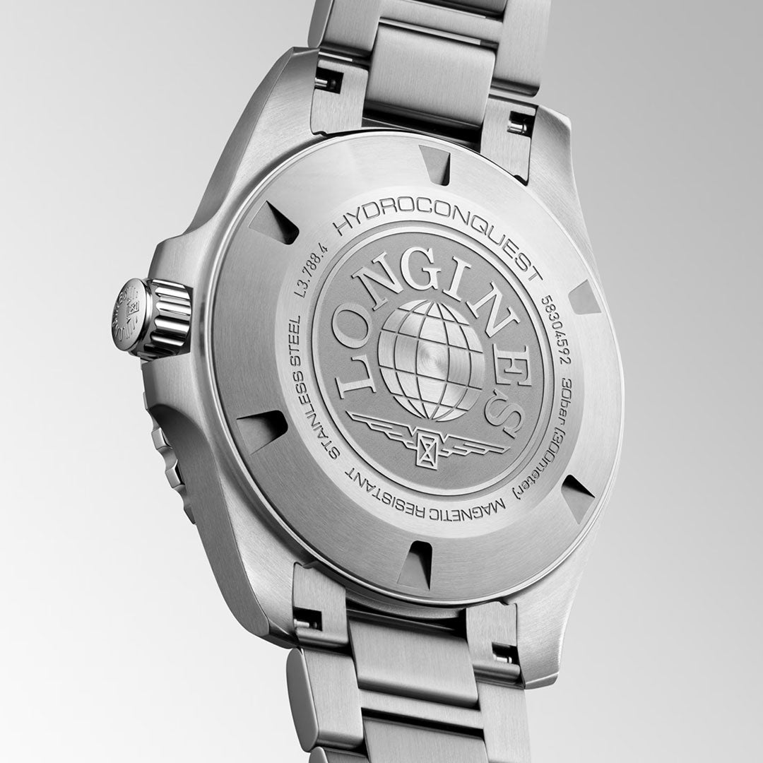 A close-up of the back of the Longines Hydroconquest Automatic 42mm Watch showcases engraved Longines branding, a globe motif, reference numbers, and its brushed stainless steel bracelet.