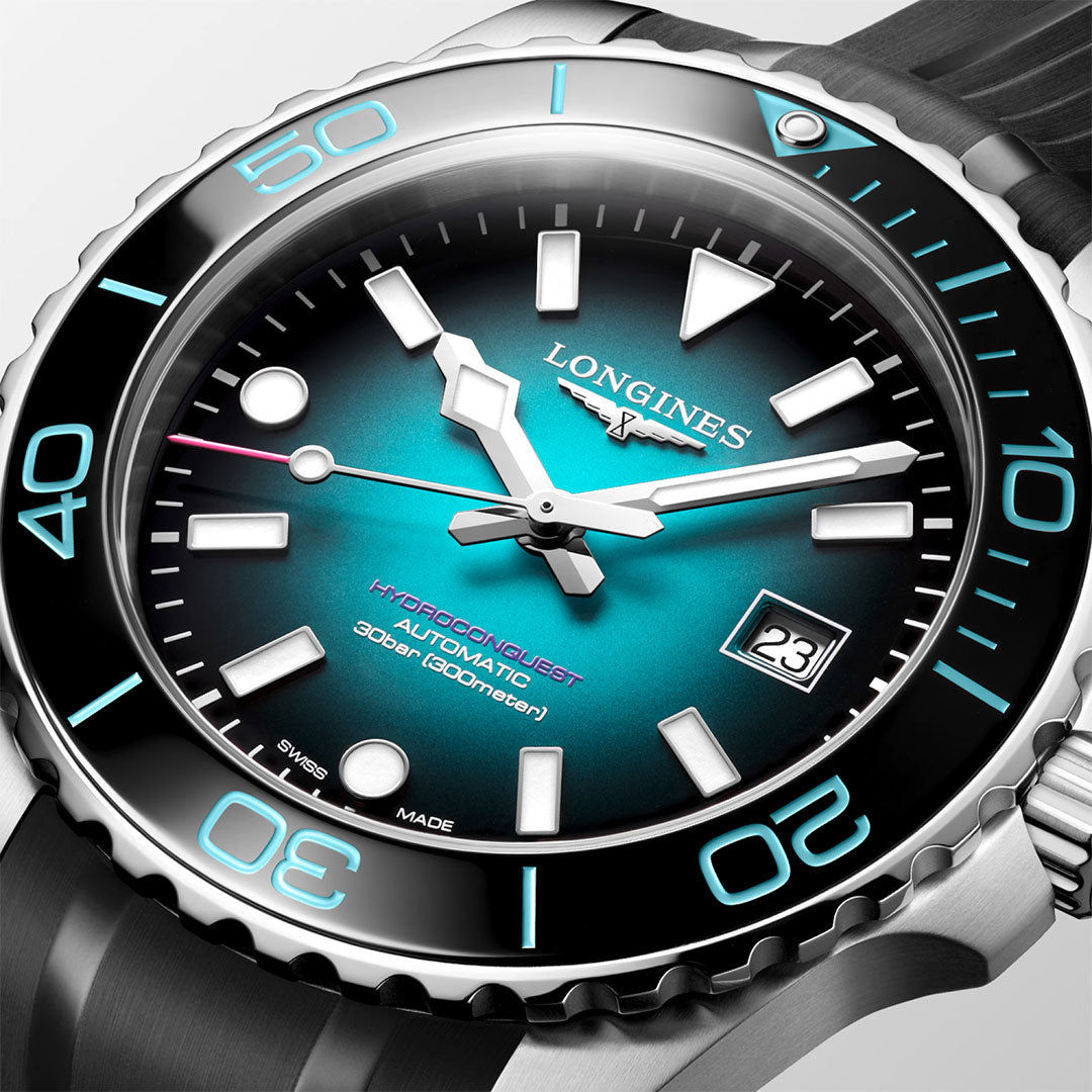 A close-up view of the Longines Hydroconquest 2026 Commonwealth Games Automatic 42mm Watch Limited Edition by Longines, featuring a teal and black gradient dial, bold white hands and markers, a date window, a black rotating bezel, and a durable stainless steel case.