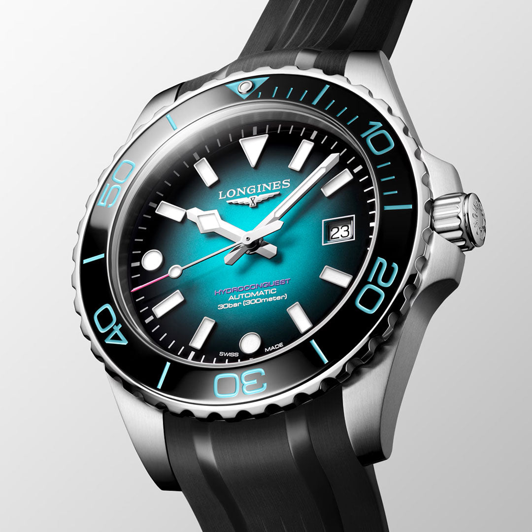 A close-up of the Longines Hydroconquest 2026 Commonwealth Games Automatic 42mm Limited Edition watch, featuring a blue gradient dial with bold white markers, date display, and a black rubber strap, set against a plain light background.