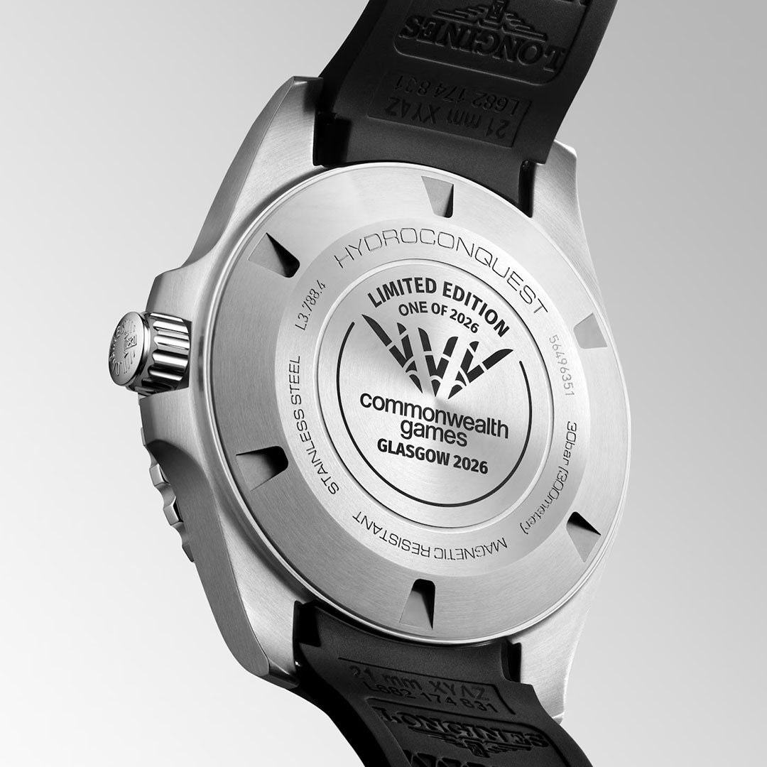 Close-up of the back of the Longines Hydroconquest 2026 Commonwealth Games Automatic 42mm Watch Limited Edition, featuring engraved text: “HYDROCONQUEST,” “LIMITED EDITION,” “commonwealth games GLASGOW 2026,” and product details. The watch has a black strap and a brushed metal finish.