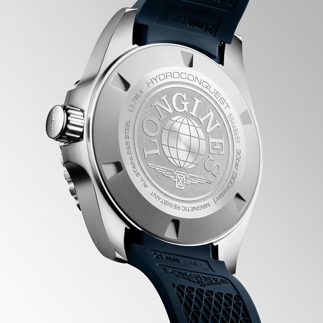 Close-up of the back of the Longines HydroConquest GMT Automatic 41mm Watch from the renowned Longines Sport Collection, featuring engraved branding, a globe motif, and technical details on a blue rubber strap. Swiss Super-LumiNova enhances visibility for exceptional performance.