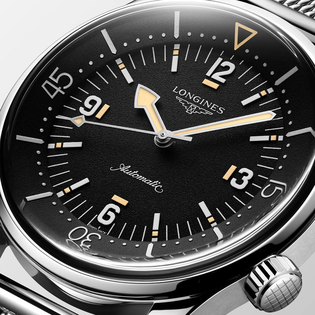 Close-up of the Longines Legend Diver 59 Automatic 42mm watch, featuring a black dial, silver Swiss Super-Luminova hour markers, yellow accents, and a polished stainless steel case with crown on the right. Time displayed: 10:09:38.