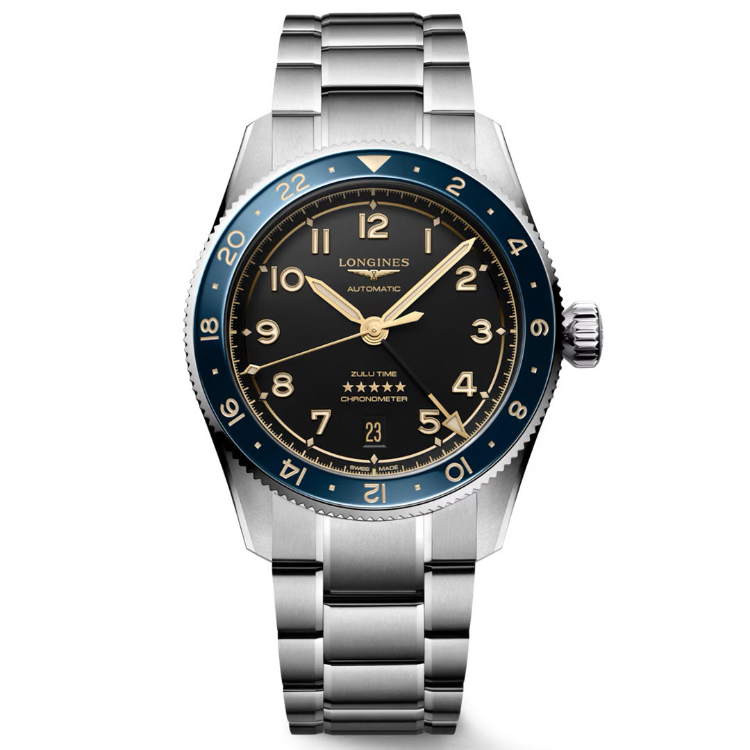 Introducing the Longines Spirit Zulu Time Automatic 39mm Watch by Longines—a stainless steel timepiece featuring a striking blue bezel, black dial with gold numerals, silver hands, and a durable metal bracelet. The dial is marked with “Longines,” “Automatic,” and “5 stars” just above the date window at 6 o’clock. Chronometer-certified and inspired by the iconic Longines Spirit Zulu Time collection, this watch offers dual time zone functionality to meet the needs of today’s modern explorers.