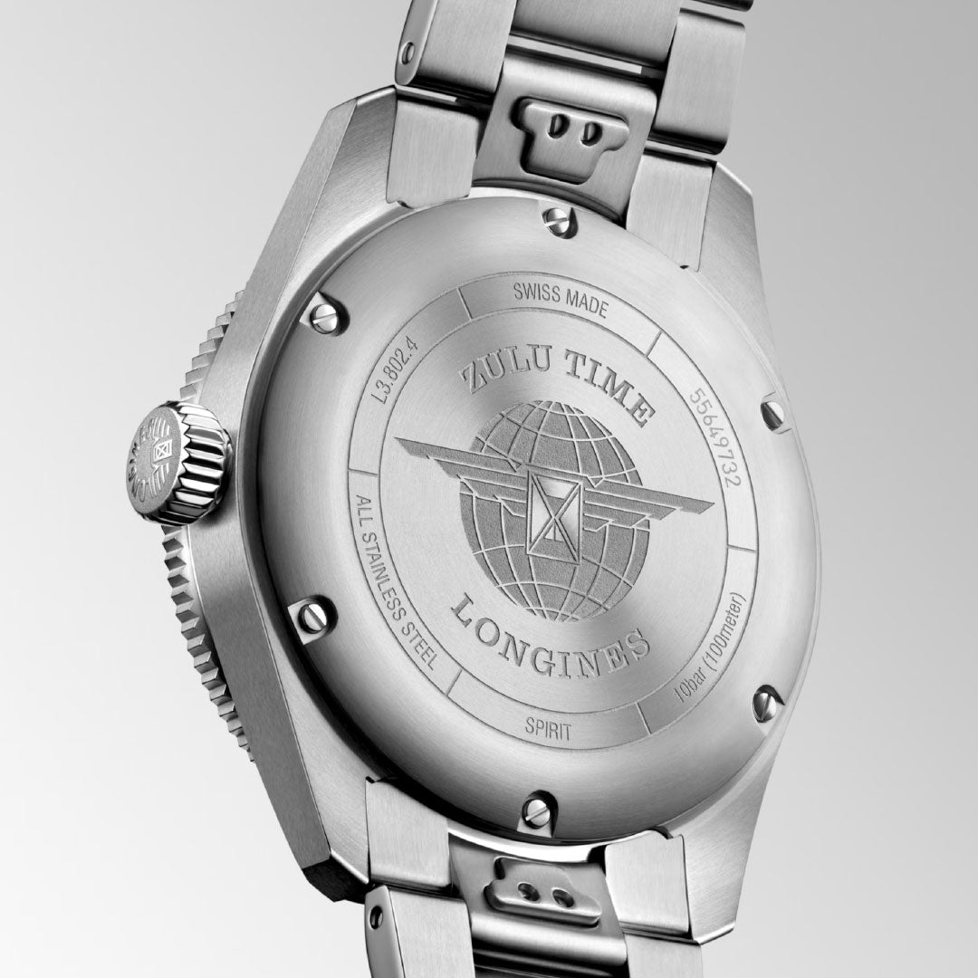 Close-up of the Longines Spirit Zulu Time Automatic 39mm Watch’s back, showing engraved details like "ZULU TIME," "SWISS MADE," serial numbers, and a winged hourglass emblem on its chronometer-certified stainless steel case and bracelet.
