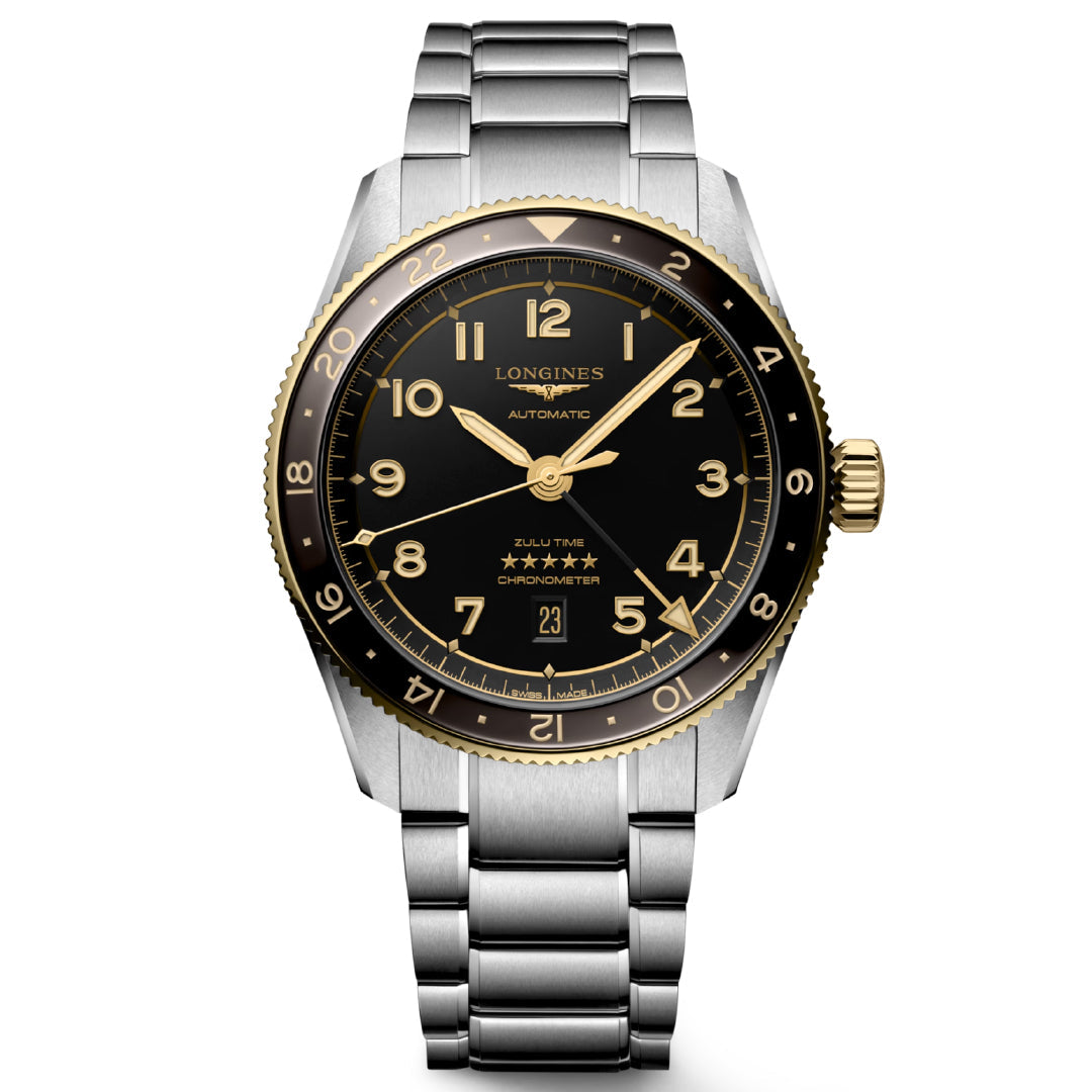 The Longines Spirit Zulu Time Automatic 42mm Watch features a silver metal band, black dial with gold Arabic numerals, and gold-toned bezel and crown. Known for its chronometer-certified precision, it offers dual time zone functionality and a date window at 6 o'clock.