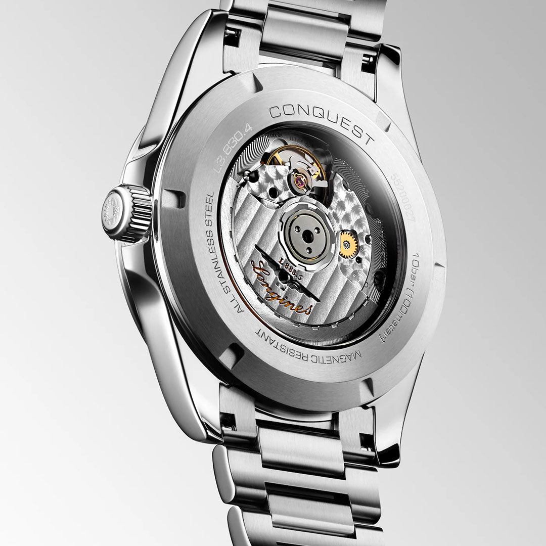 Close-up of the back of the Longines Conquest Automatic 41mm Watch by Longines, featuring a transparent case that showcases its intricate mechanical movement and engraved detailing along the edge—a refined and elegant timepiece designed for everyday wear.