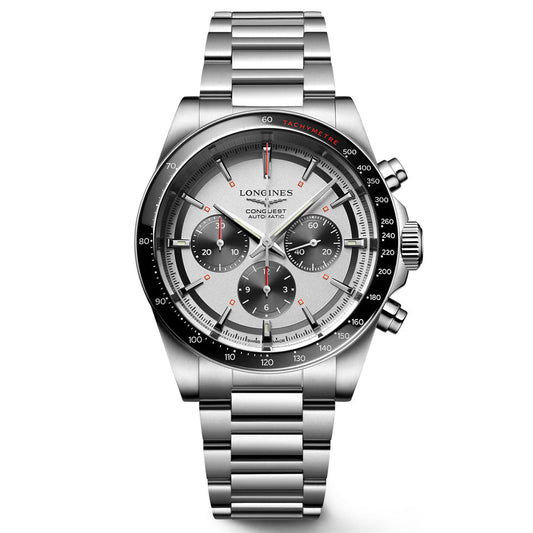 The Longines Conquest Chronograph Automatic 42mm Watch features a stainless steel case, silver dial with three subdials, black tachymeter bezel, red accents, and metal link bracelet—showcasing signature Longines craftsmanship.