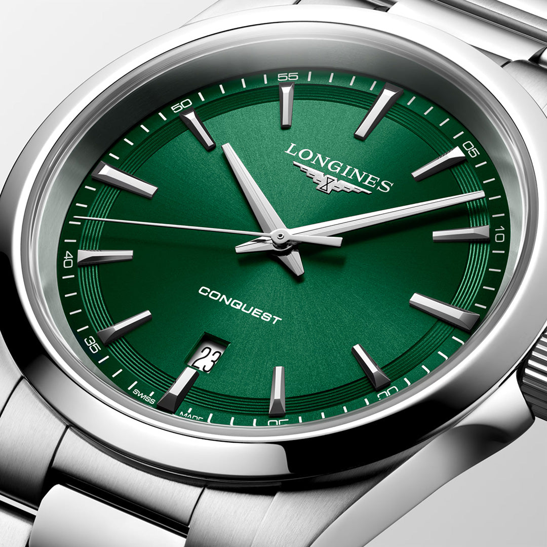 Close-up of the Longines Conquest Quartz 41mm watch, featuring a green dial with silver hour markers and hands, a date window at 6 o’clock, and a stainless steel bracelet—showcasing the refined craftsmanship of Longines.