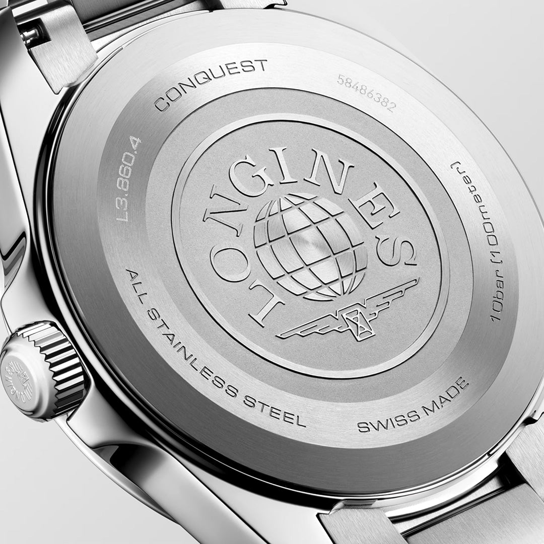 The stainless steel case back of the Longines Conquest Quartz 41mm Watch, crafted by renowned Swiss watchmaker Longines, features an engraved brand logo, globe emblem, winged hourglass icon, serial number 58486382, model number L3.860.4, along with the texts “All Stainless Steel” and “Swiss Made.”.