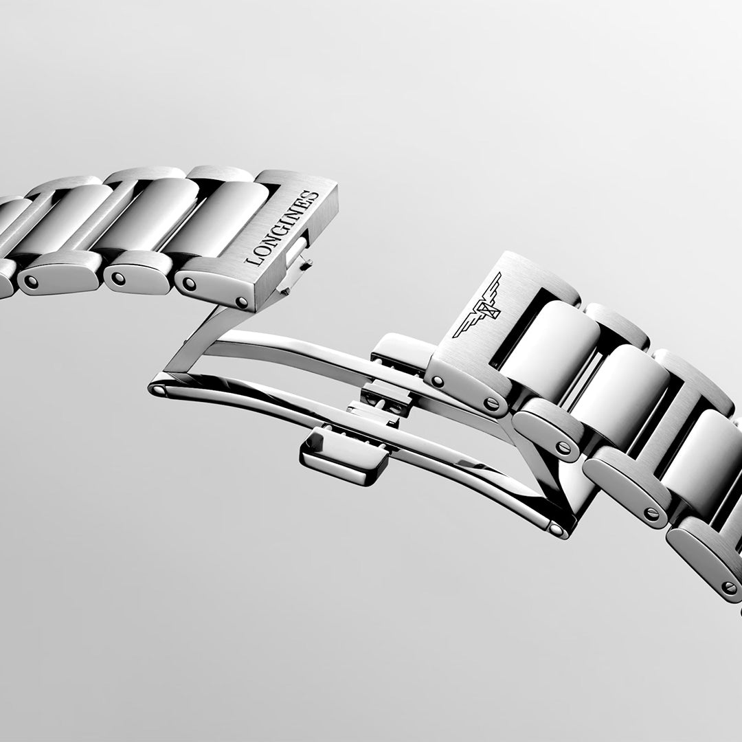 Close-up of a silver Longines Conquest Quartz 41mm watch bracelet with a deployment clasp, showcasing the renowned Swiss brand’s name and an engraved winged hourglass logo on polished metal links against a light gray background.