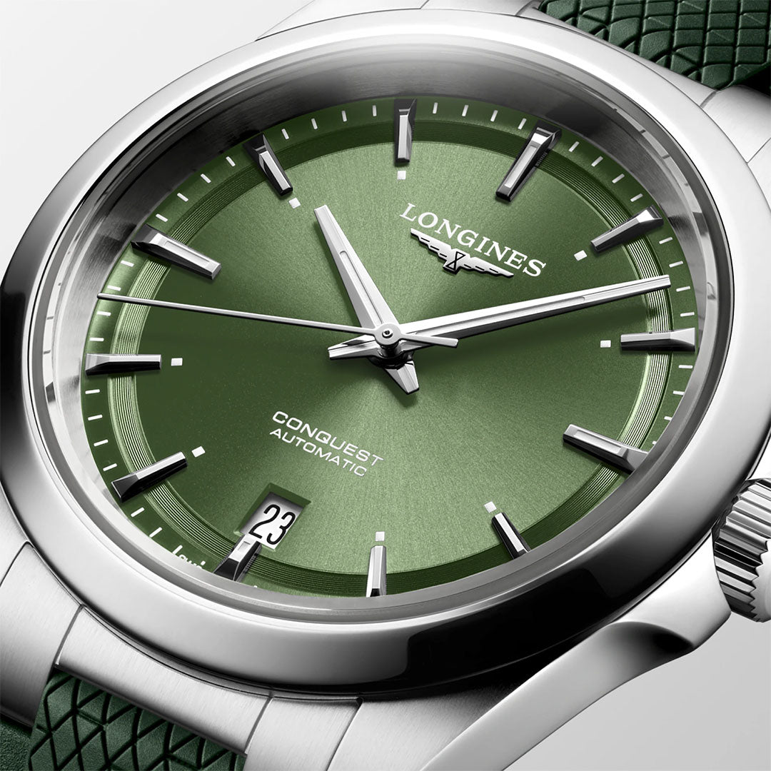 Close-up of the Longines Conquest Automatic 38mm Watch featuring a green dial, silver markers and hands, date at 6 o'clock, and a textured green strap. The ideal everyday accessory from Longines.