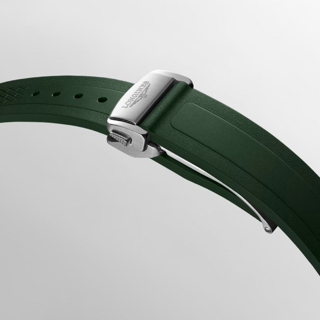 Close-up of a green rubber strap with a silver deployment clasp engraved "Longines" for the Longines Conquest Automatic 38mm Watch, set against a plain light gray background.