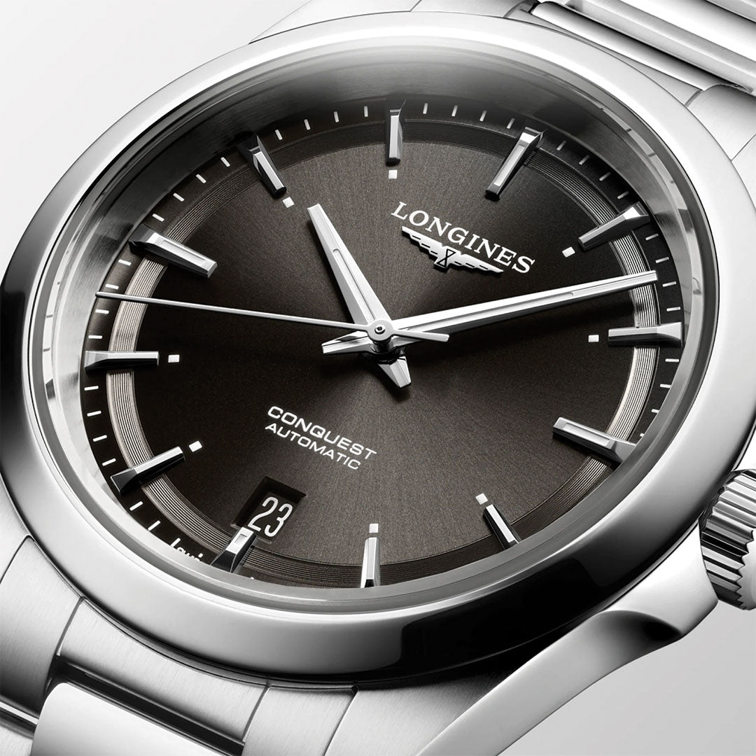 Close-up of the Longines Conquest Automatic 38mm Watch, featuring a dark dial with silver hour markers and hands, date window at 6 o’clock, and a stainless steel bracelet—exemplifying Longines’ sporty elegance.