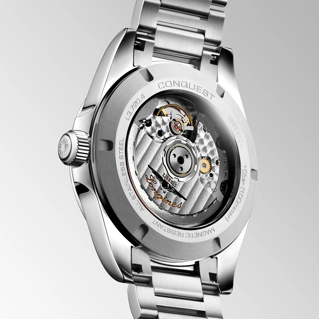 Close-up of the Longines Conquest Automatic 38mm Watch's stainless steel back, revealing its mechanical movement through a transparent case back engraved with "LONGINES," "Conquest," and sporty elegance details.