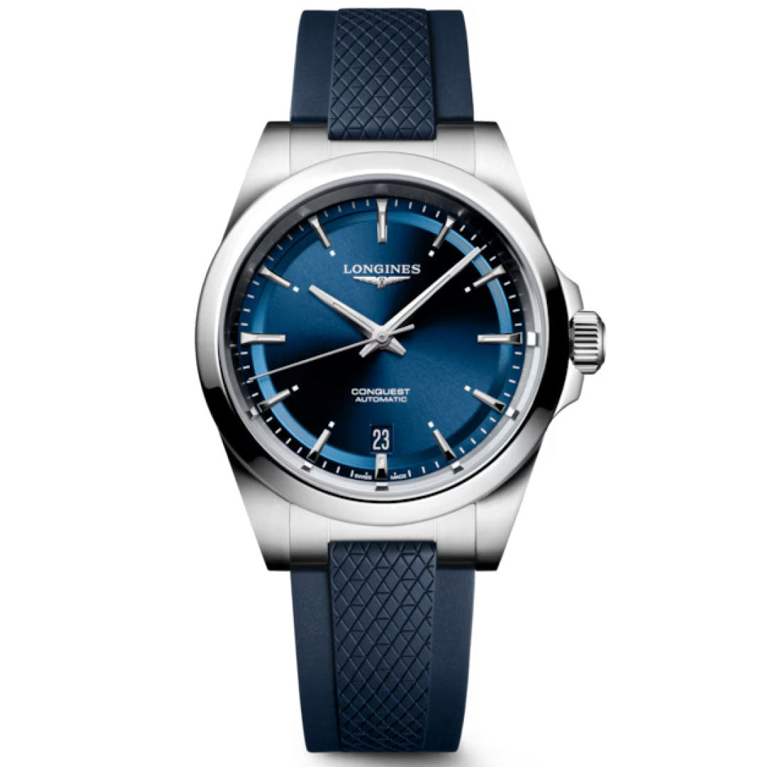The Longines Conquest Automatic 38mm Watch features a silver case, blue gradient dial, silver hour markers, date at 6 o’clock, and a textured blue rubber strap.